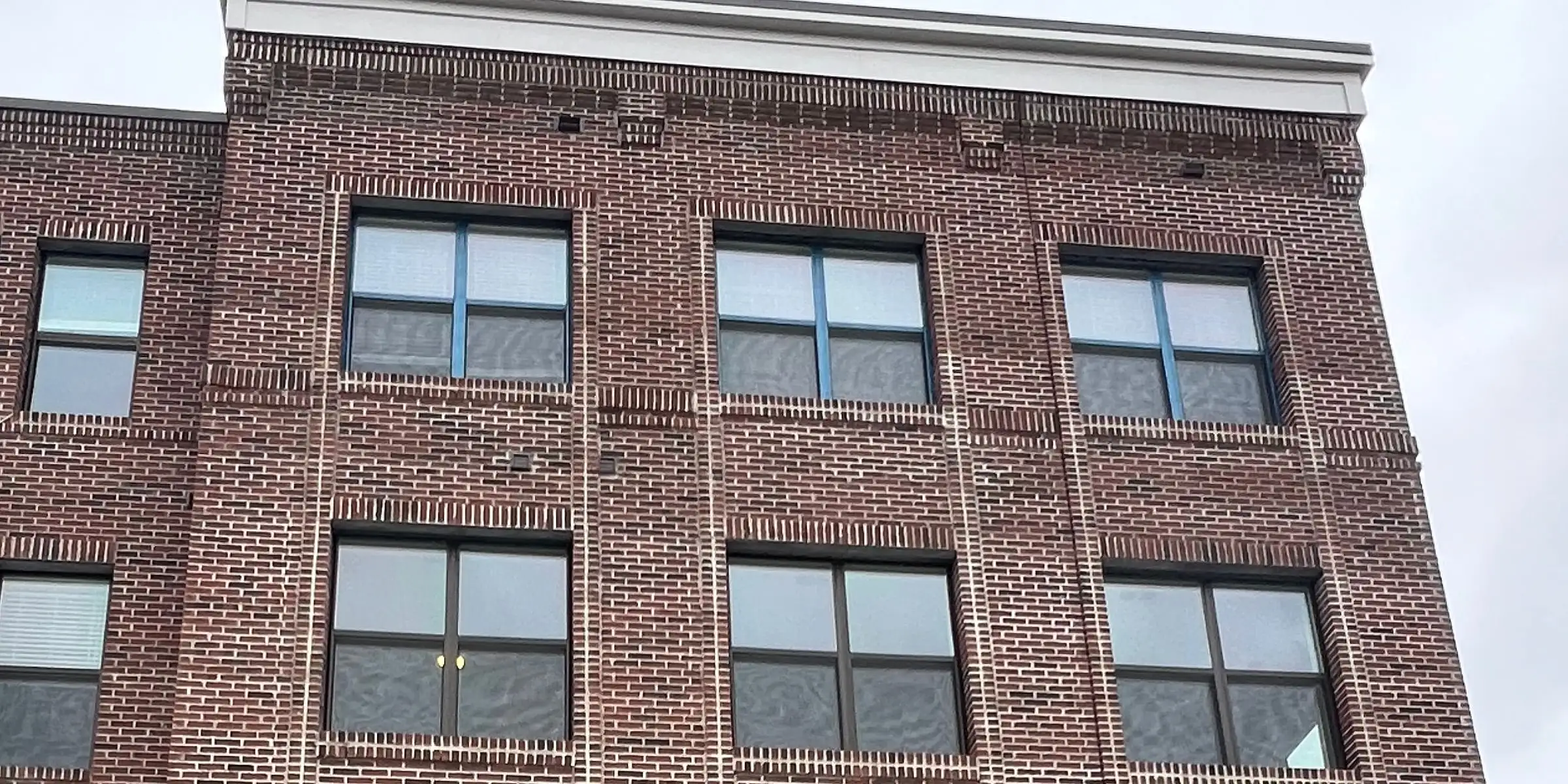 Four-story brick facade by a CDF crew