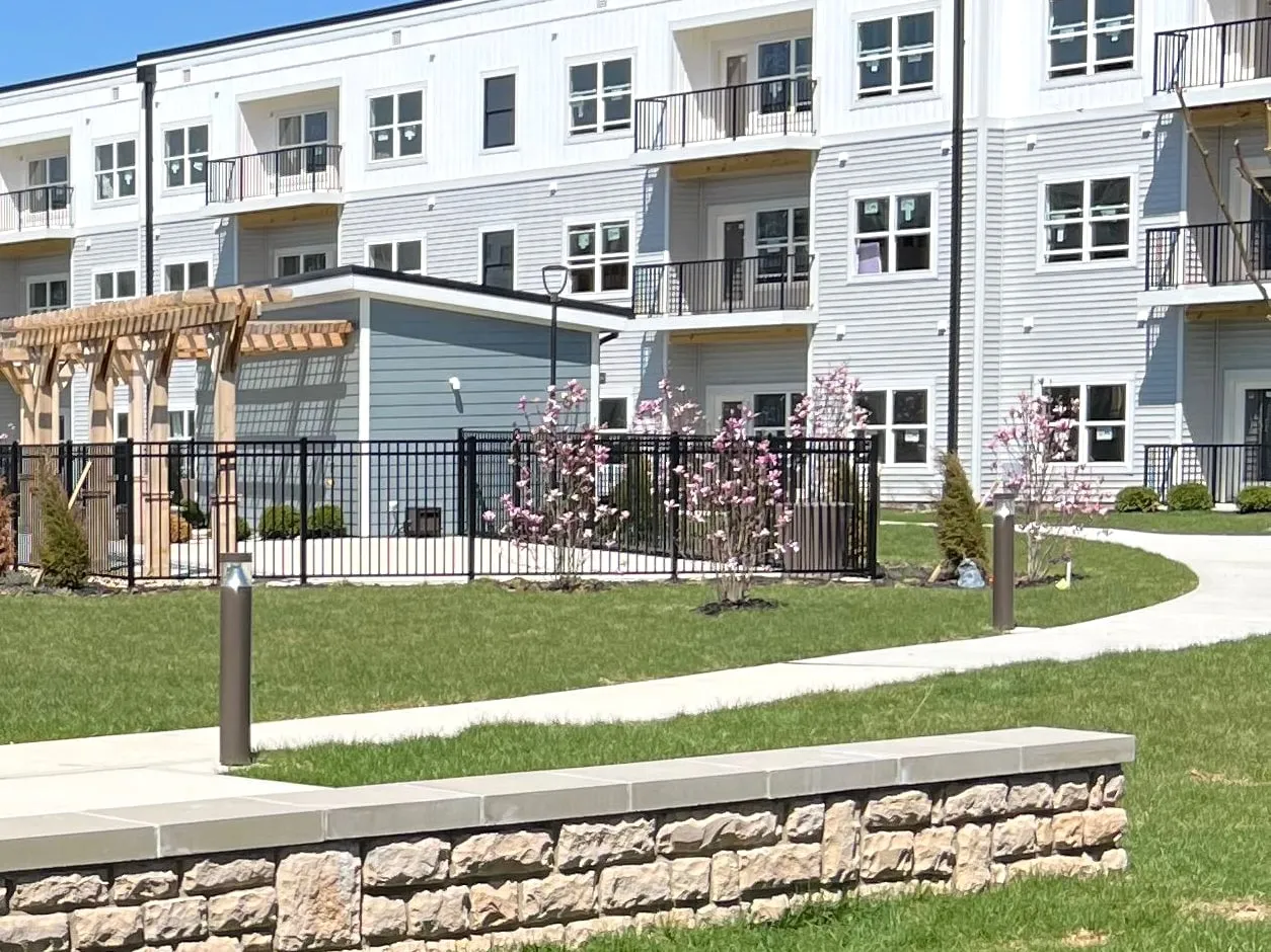 Finished apartment community courtyard with stone seat walls